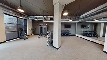 A spacious gym with a variety of equipment is shown.