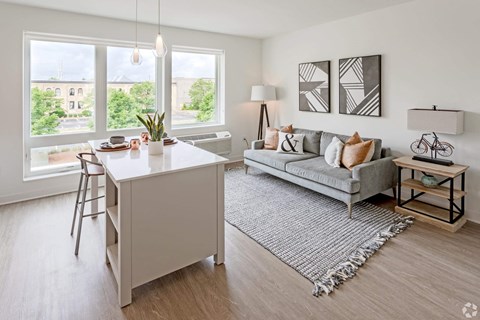 a living room with a couch and a kitchen