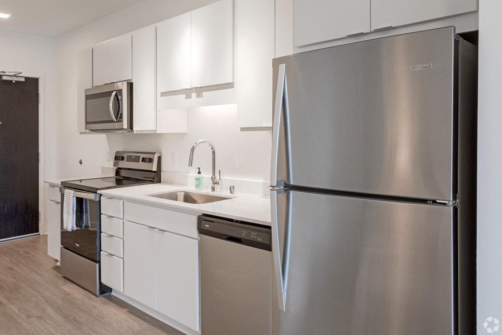 a kitchen with stainless steel appliances and white cabinets