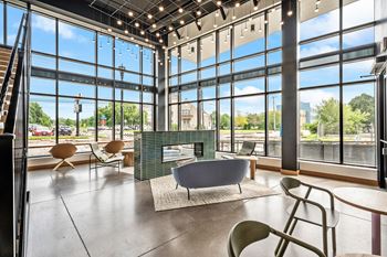 A modern living room with a fireplace and a view of the city.