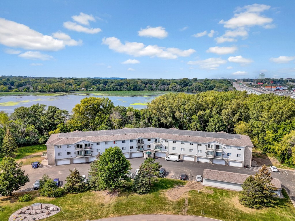 A large white building with a parking lot in front of it.