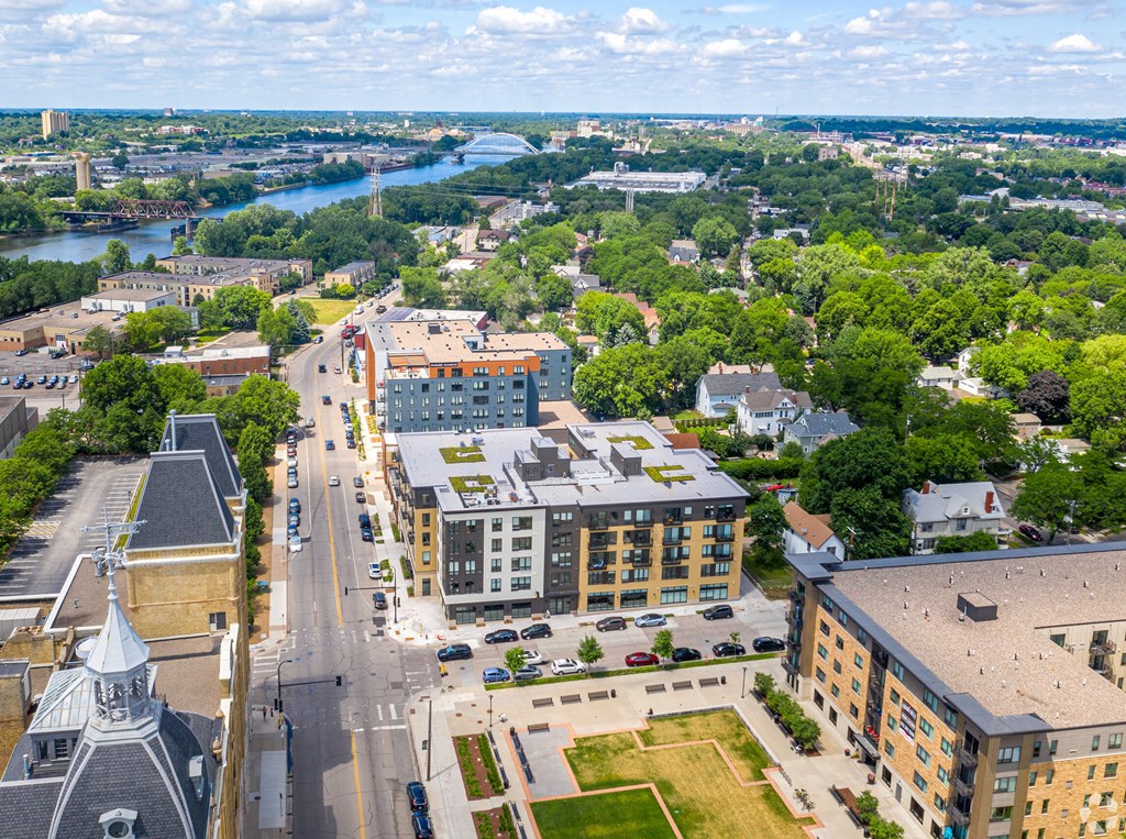an aerial view of a city with buildings and a river