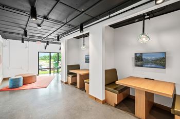 A room with a long table and chairs.