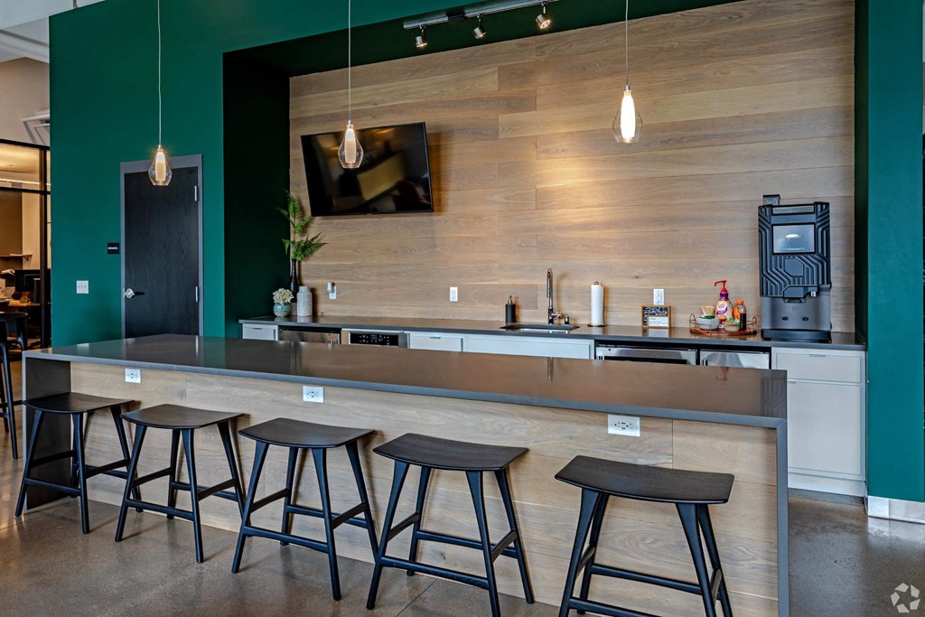 a kitchen with a counter and bar stools