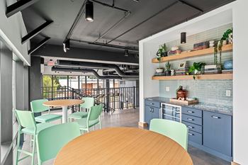 A modern kitchen with a dining table and chairs.