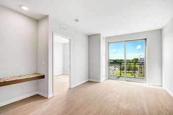 a living room with a large window and a balcony