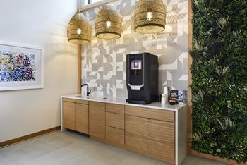 A wall-mounted cabinet with a coffee machine on top.