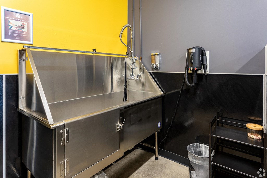 a stainless steel sink in a kitchen with a phone