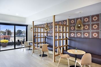 A room with a table and chairs and a wall with a pattern on it.