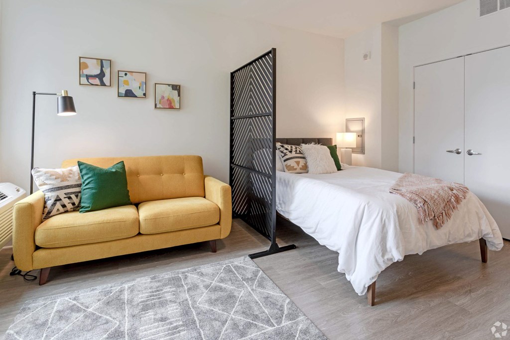 a bedroom with a bed and a couch