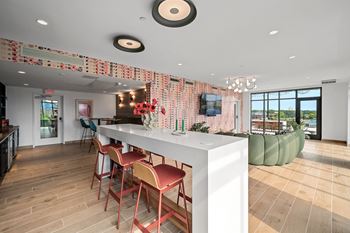 A modern kitchen with a bar area and a dining table.
