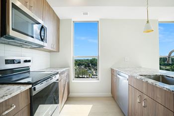 a kitchen with stainless steel appliances and a window