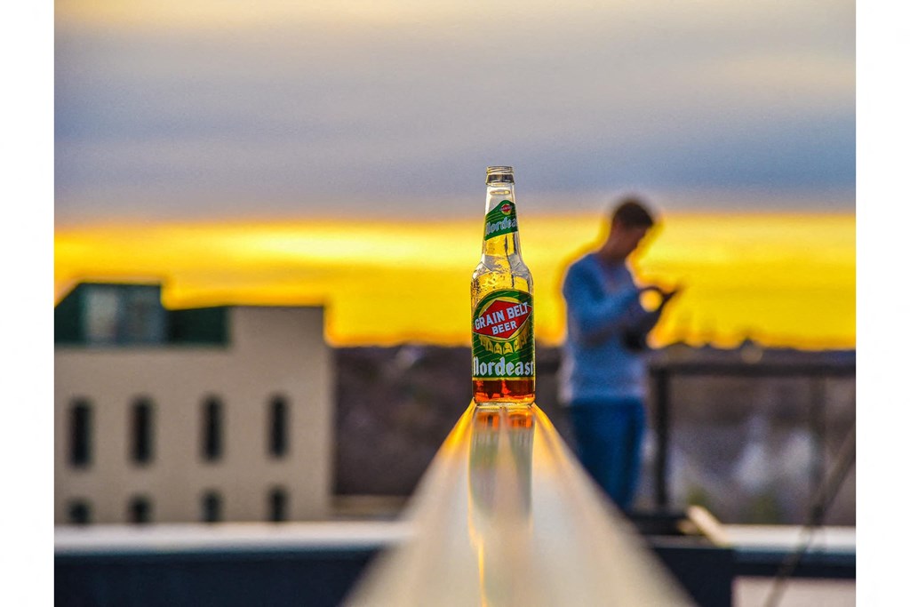 a bottle of beer sitting on top of a roof