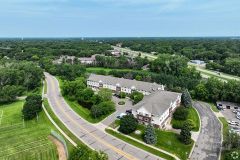 A large building with a green lawn in front of it.
