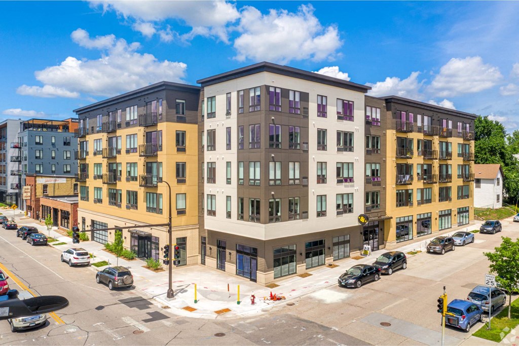a rendering of a new apartment building on the corner of a city street
