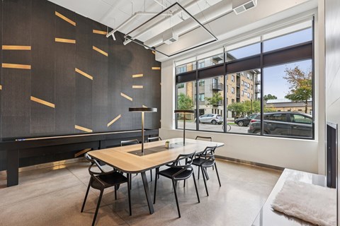 A room with a pool table and a view of the street outside.