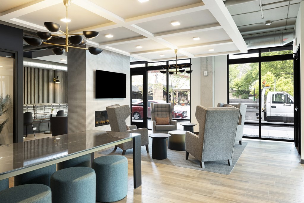 the lobby of a hotel with chairs and a table
