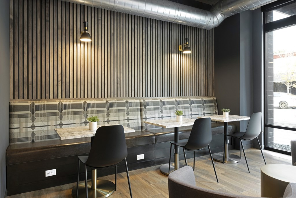 a restaurant with wooden tables and chairs and a large window