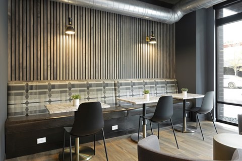 a restaurant with wooden tables and chairs and a large window