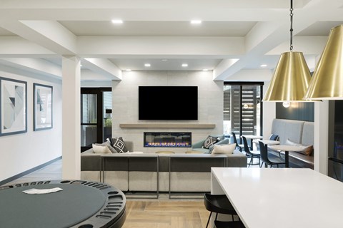 a kitchen and living room with a fireplace and a tv