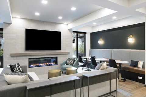 a living room with a fireplace and a large screen tv