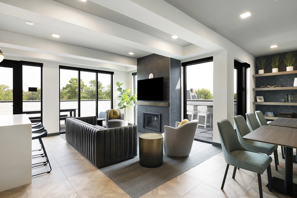a living room with a fireplace and a table and chairs
