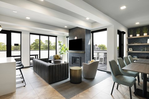 a living room with a fireplace and a table and chairs