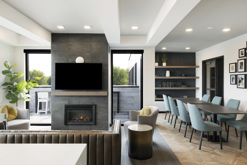 a living room with a fireplace and a table and chairs