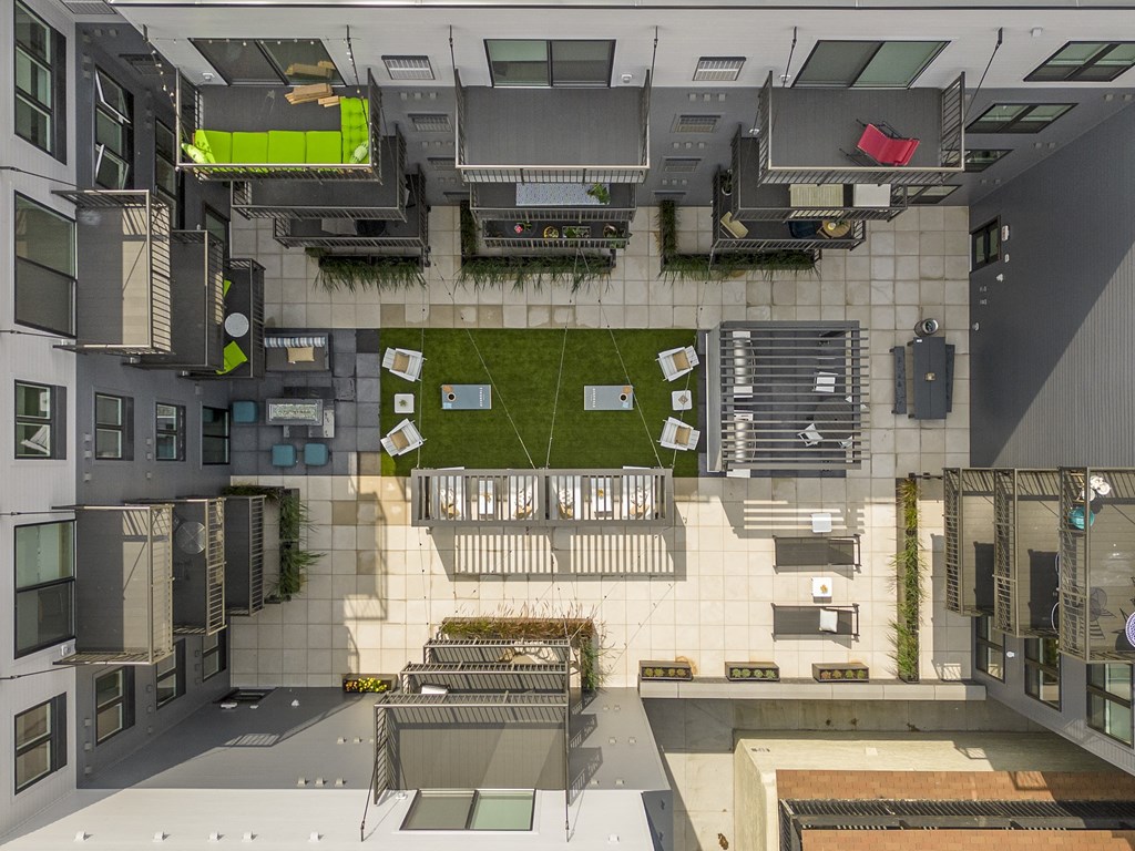 an overhead view of a building with a courtyard and a lawn