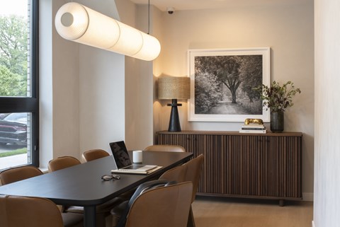 A modern dining room with a black table and chairs.