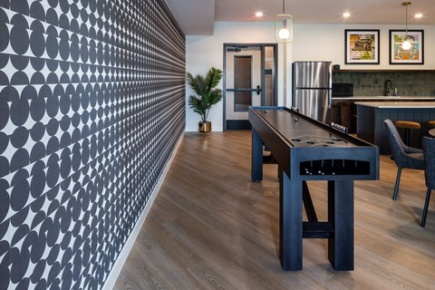A modern kitchen with a long table and chairs.