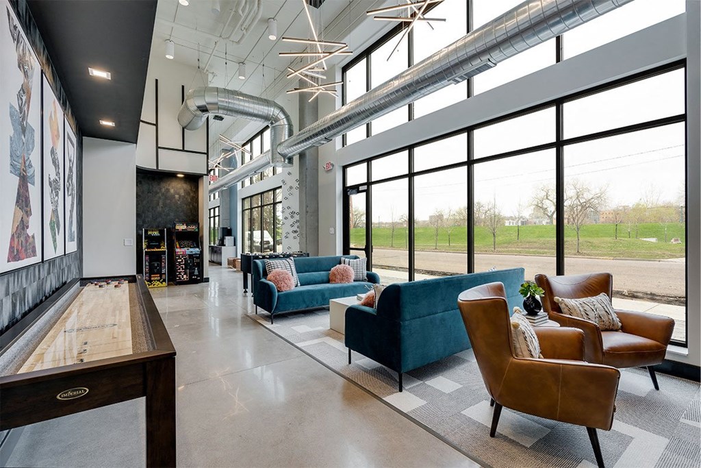 the lobby of a building with couches and chairs