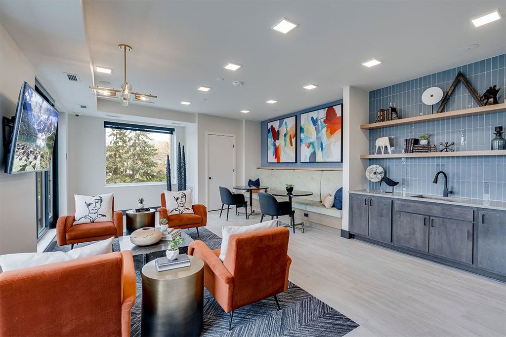 a living room with furniture and a kitchen