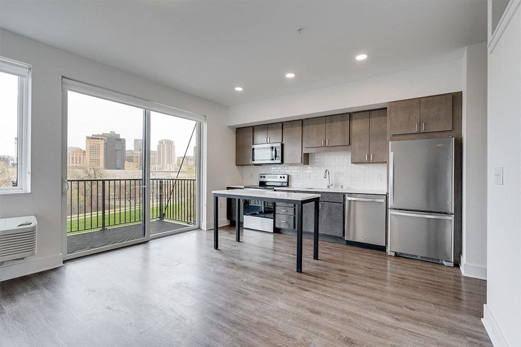 a kitchen with stainless steel appliances and a large window