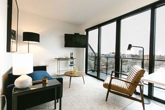 a bedroom with a bed and a chair in a room