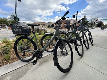 A bicycle leasing station with bikes parked.