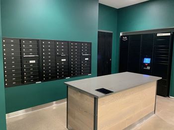 a bunch of mailboxes and a counter in a room with a green wall