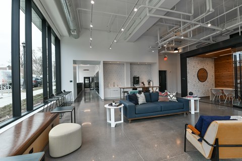 A modern living room with a blue couch and a white coffee table.