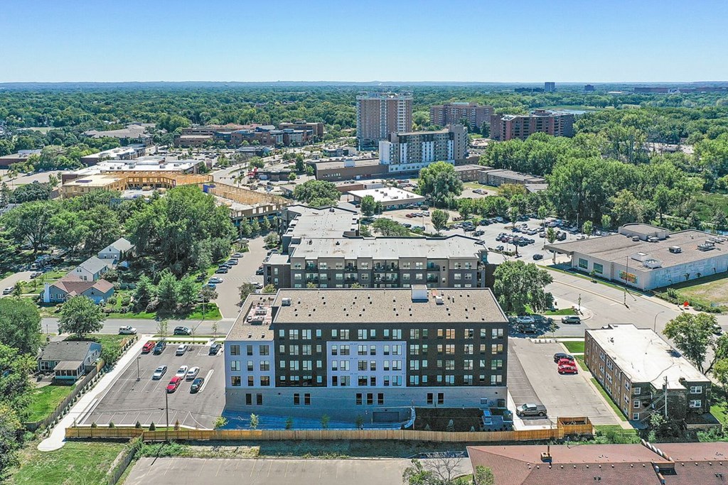 A large building with a parking lot in front of it.