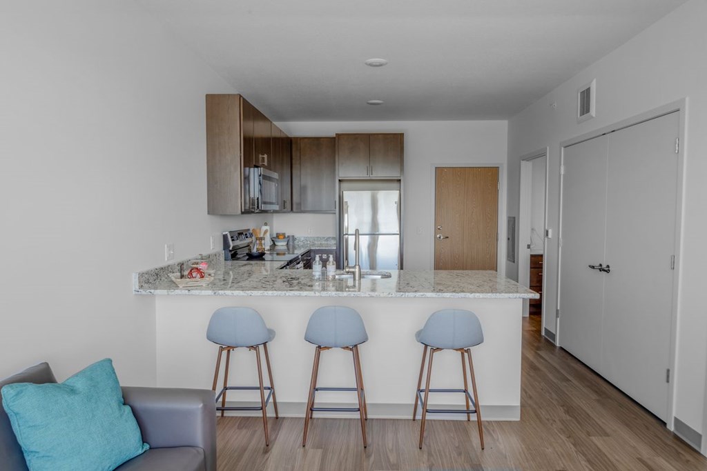 A kitchen with a bar area and a couch.
