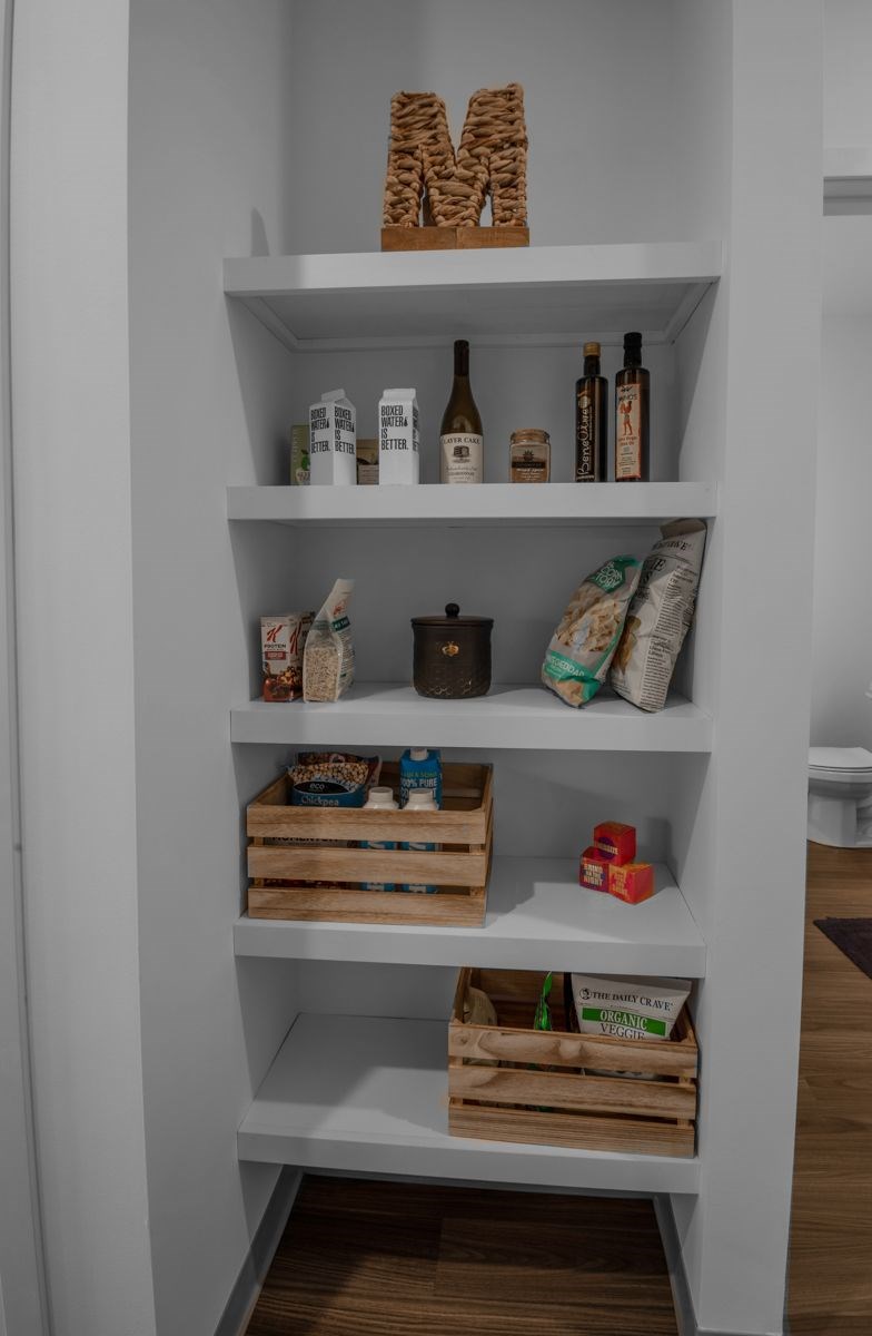A white shelf with various items on it.