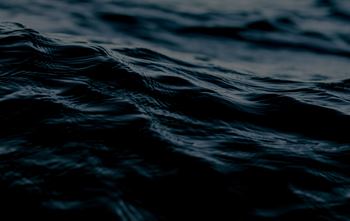 A close up of dark blue water with ripples.