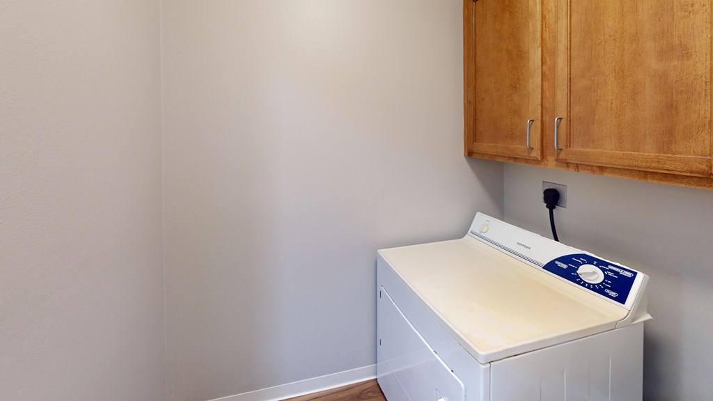 A white washing machine with a blue sticker on it.