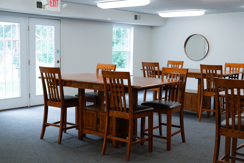 A conference room with a long table and chairs.