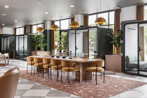 A modern dining room with a large table and chairs.