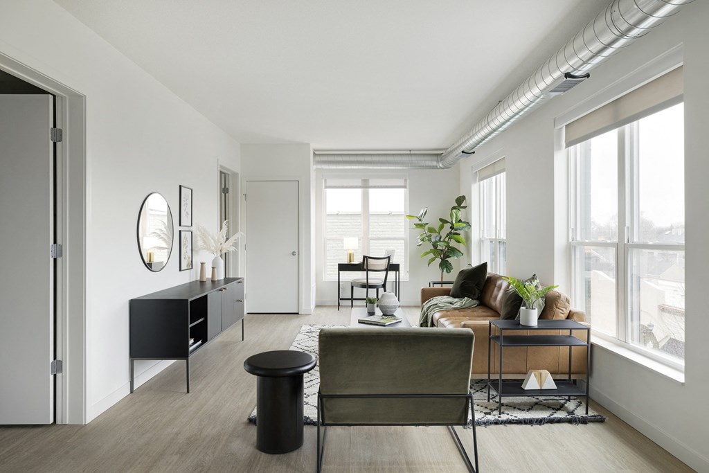 a living room with white walls and hardwood floors