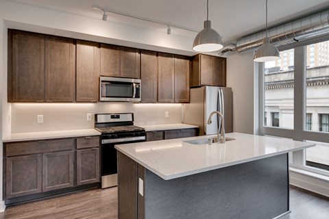 a kitchen with wooden cabinets and a white counter top
