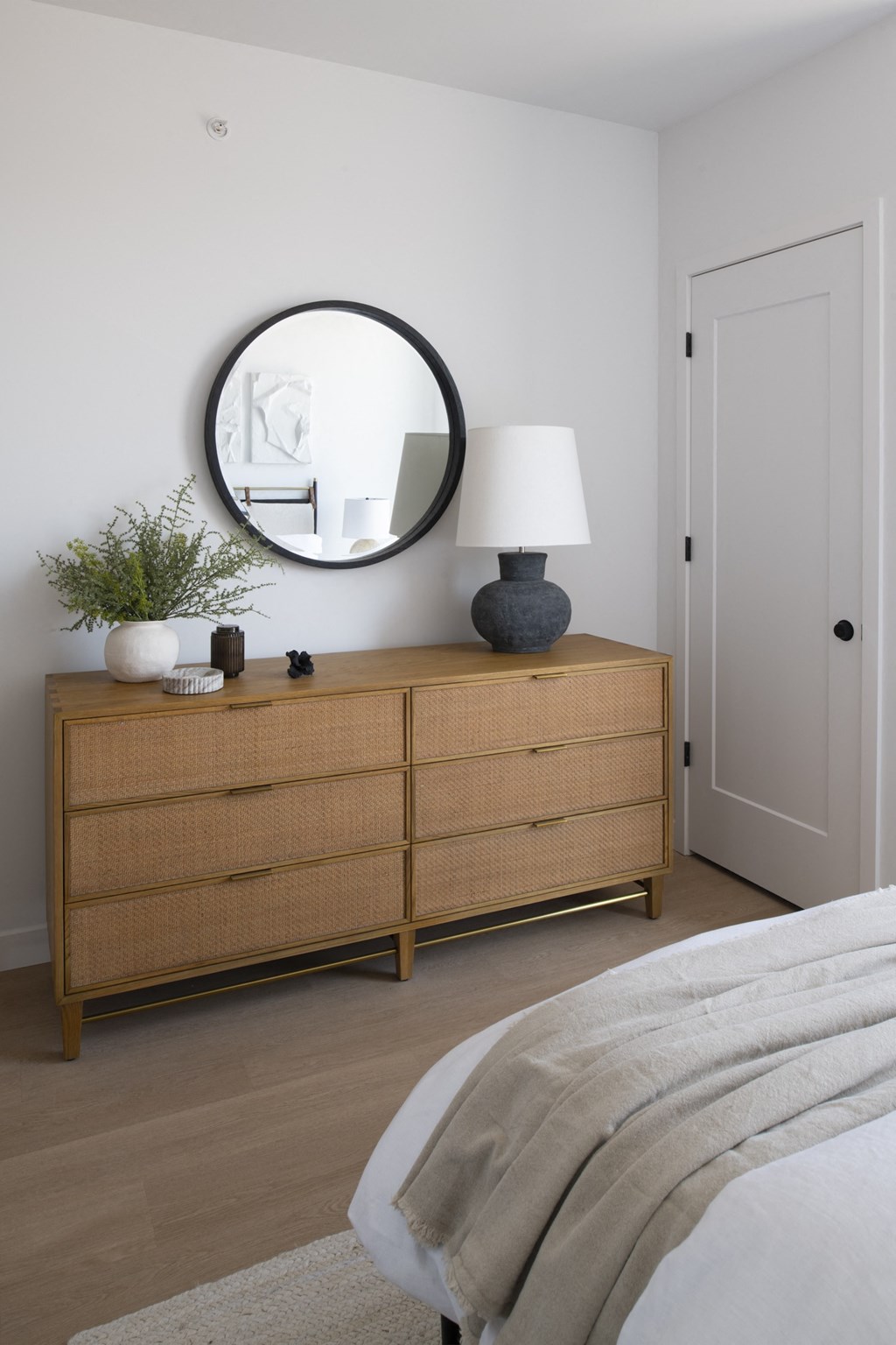 a bedroom with a dresser and mirror