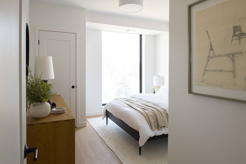 a bedroom with a bed and a dresser