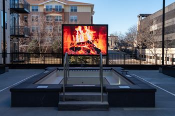 A billboard with a fiery image is displayed in an outdoor setting.